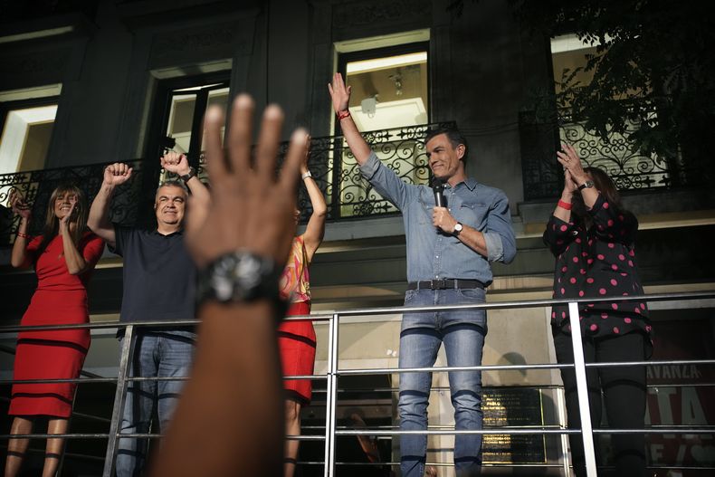El líder del Partido Socialista y presidente del Gobierno español, Pedro Sánchez, saluda a sus seguidores ante la sede del partido en Madrid, España, el domingo 23 de julio de 2023. (AP Foto/Emilio Morenatti)