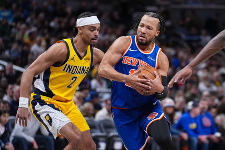 Jalen Brunson, de los Knicks de Nueva York, elude a Andrew Nembhard, de los Pacers de Indiana, en el partido del viernes 13 de marzo de 2026 (AP Foto/Michael Conroy)