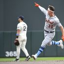 Kerry Carpenter de los Tigres de Detroit apunta hacia donde pegó su jonrón mientras recorre las bases superando al segunda base de los Mellizos de Minnesota Kyle Farmer en el encuentro del domingo 18 de junio del 2023. (AP Foto/Craig Lassig)