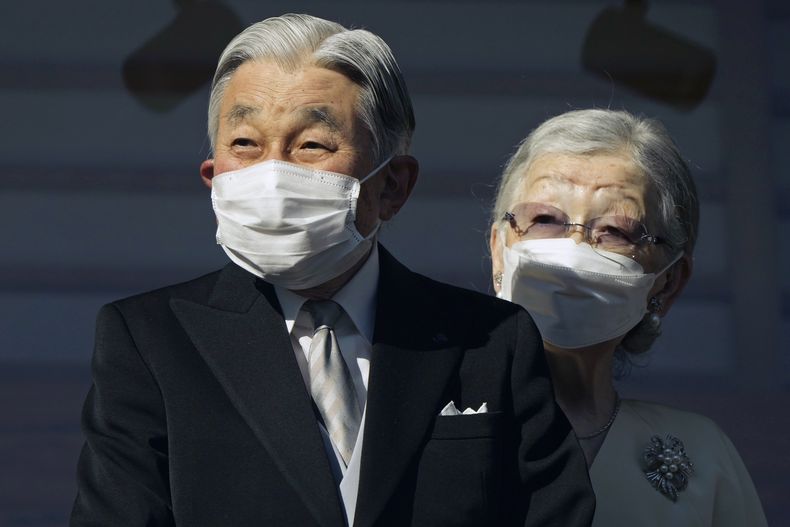 ARCHIVO - El emperador emérito de Japón, Akihito, y la emperatriz emérita, Michiko, saludan a simpatizantes a través de un cristal antibalas durante su aparición de Año Nuevo en el Palacio Imperial en Tokio, el 2 de enero de 2023. (Franck Robichon/Pool Foto via AP, Archivo)