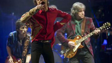 ARCHIVO - Mick Jagger, en el centro, Ronnie Wood, a la izquierda, y Mick Taylor, de la banda de rock británica The Rolling Stones, actúan en el escenario principal de la Pirámide en Glastonbury, Inglaterra, el 29 de junio de 2013. (Joel Ryan/Invision/AP, archivo)