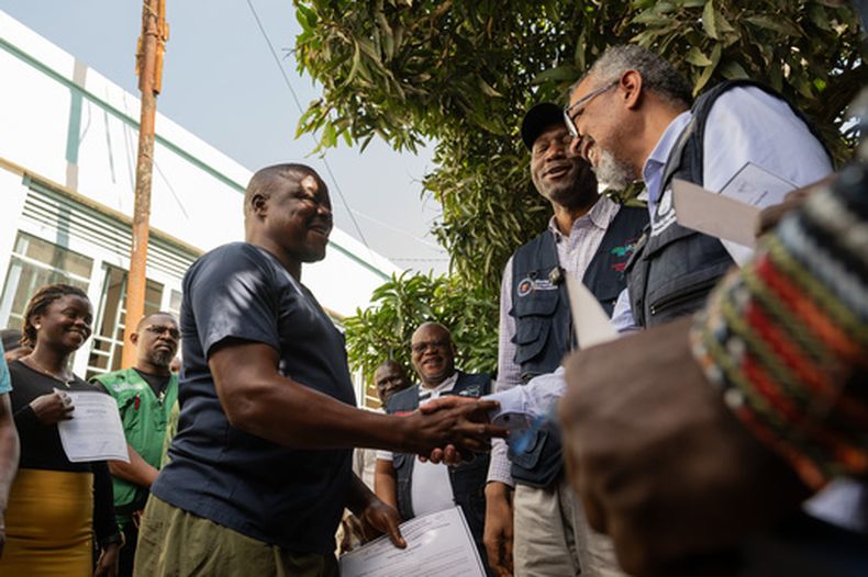 El director general de la Organización Mundial de la Salud (OMS), Tedros Adhanom Ghebreyesus, derecha, saluda a Ezo Etienne, un trabajador sanitario que logró recuperarse del ébola en Bunia, República Democrática del Congo, el domingo 31 de mayo de 2026. (AP Foto/Moses Sawasawa)