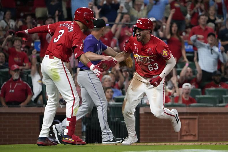 Michael Siani de los Cardenales de San Luis felicitado por su compañero Dylan Carlson tras anotar en la octava entrada del juego ante los Rockies de Colorado el viernes 7 de junio del 2024. (AP Foto/Jeff Roberson)