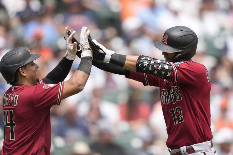 El cubano de los Diamondbacks de Arizona, Lourdes Gurriel Jr., recibe las felicitaciones de su compañero, el venezolano Gabriel Moreno, después de conectar un jonrón de tres carreras en la quinta entrada del partido ante los Tigres de Detroit, el sábado 10 de junio de 2023, en Detroit.(AP Foto/Carlos Osorio)