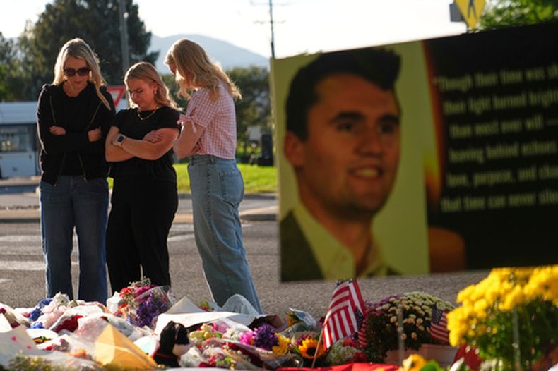 ARCHIVO - Tres mujeres, en el memorial instalado en el exterior de la Utah Valley University luego del asesinato del director general y cofundador de Turning Point USA, Charlie Kirk, el 13 de septiembre de 2025, en Orem, Utah. (AP Foto/Lindsey Wasson, archivo)