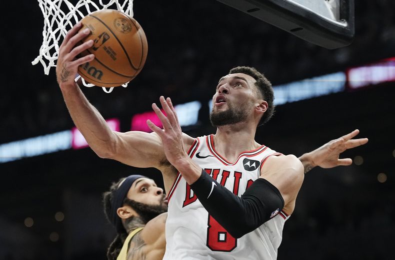 ARCHIVO - Zach LaVine, de los Bulls de Chicago, encesta frente a Gary Trent Jr. de los Raptors de Toronto durante el partido del 24 de noviembre de 2023 (Frank Gunn/The Canadian Press via AP, File)
