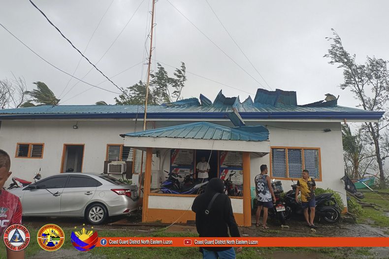 En esta imagen, distribuida por la Guardia Costera de Filipinas, efectivos de la agencia, en el exterior de uno de sus edificios, dañado por el paso del tifón Yinxing por Santa Ana, en la provincia de Cagayan, en el norte de Filipinas, el 7 de noviembre de 2024. (Guardia Costera de Filipinas vía AP)