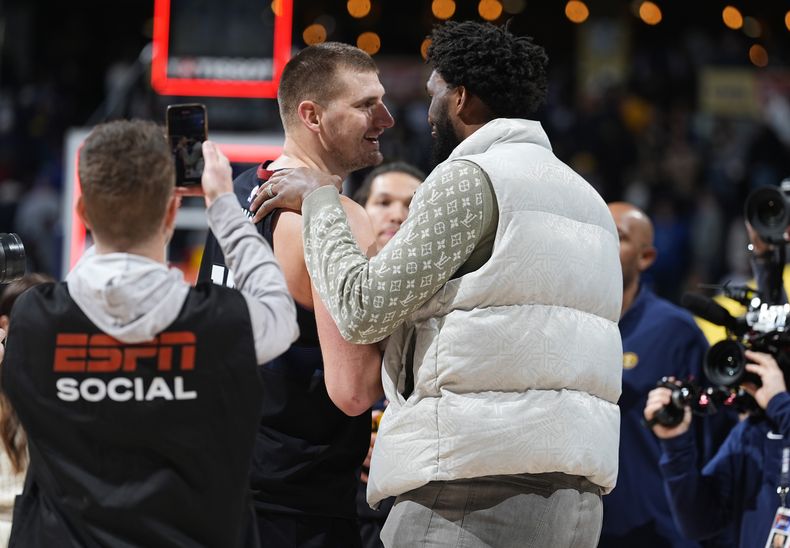 El pívot de los Nuggets de Denver Nikola Jokic (izquierda) saluda al centro de los 76ers de Filadelfia Joel Embiid luego del juego de baloncesto de la NBA, el sábado 27 de enero de 2024, en Denver. (AP Foto/David Zalubowski)