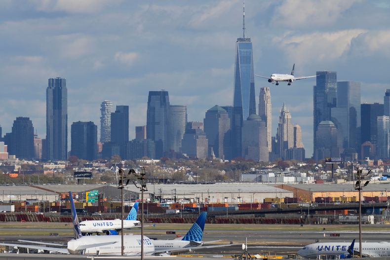 La ciudad de Nueva York se ve detrás de un avión que se aproxima al Aeropuerto Internacional de Newark, el jueves 6 de noviembre de 2025, en Newark, Nueva Jersey. (AP Foto/Seth Wenig)