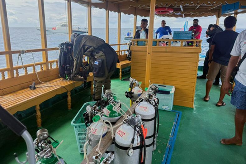 En esta imagen publicada por la División de Medios de la presidencia de Maldivas, un buzo finlandés se prepara para intentar recuperar los cuerpos de dos de los cuatro italianos fallecidos en el interior de una cueva submarina en un atolón este mes, en la isla de Alimathaa, en el atolón Vaavu, Maldivas, el martes 19 de mayo de 2026. (División de Medios de la presidencia de Maldivas via AP)
