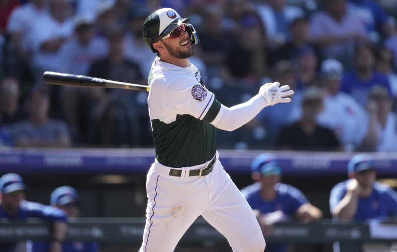 Kris Bryant, de los Rockies de Colorado, sigue con la mirada del vuelo de la pelota de su cuadrangular solitario ante el relevista de los Cachorros de Chicago Hayden Wesneski en la séptima entrada del juego de béisbol del miércoles 13 de septiembre de 2023, en Denver. (AP Foto/David Zalubowski)