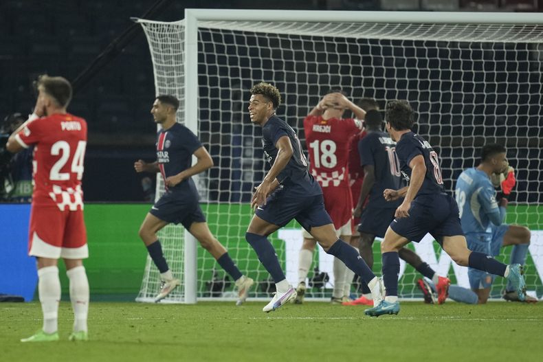 Los jugadores del París Saint-Germain festejan luego que un yerro del arquero argentino Paulo Gazzaniga les da el gol de la victoria sobre el Girona en la Liga de Campeones, el miércoles 18 de septiembre de 2024 (AP Foto/Christophe Ena)