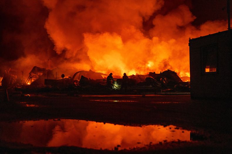 Bomberos sofocan un incendio luego de que misiles rusos alcanzaron un almacén en Kiev, Ucrania, el 5 de agosto de 2026. (AP Foto/Dan Bashakov)