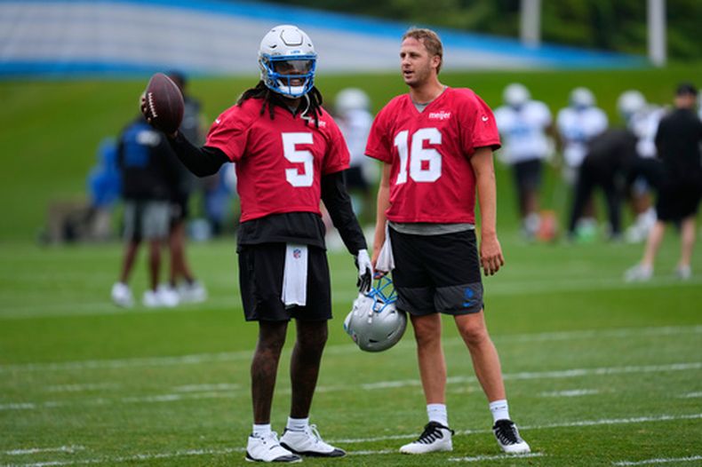 Los quarterbacks de los Lions de Detroit, Teddy Bridgewater (5) y Jared Goff (16), conversan durante la práctica en el campamento de entrenamiento del equipo de fútbol americano, en Allen Park, Míchigan, el domingo 2 de agosto de 2026. (Foto AP/Paul Sancya)