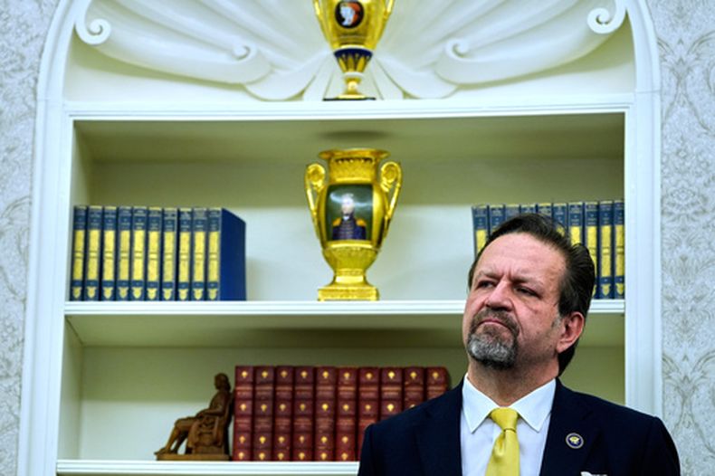 ARCHIVO - Sebastian Gorka escucha al presidente Donald Trump hablando con reporteros tras firmas órdenes ejecutivas en el Despacho Oval de la Casa Blanca, el 23 de abril de 2025, en Washington. (AP Foto/Alex Brandon, Archivo)