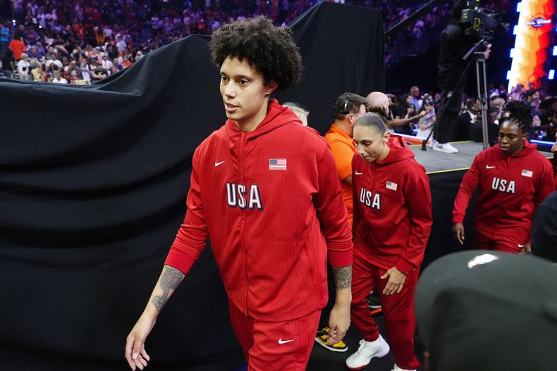 Brittney Griner, izquierda, Diana Taurasi y Chelsea Gray, del equipo de Estados Unidos, caminan rumbo a la duela para el Juego de Estrellas para entrentar al equipo de la WNBA, el sábado 20 de julio de 2024, en Phoenix. (AP Foto/Ross D. Franklin)