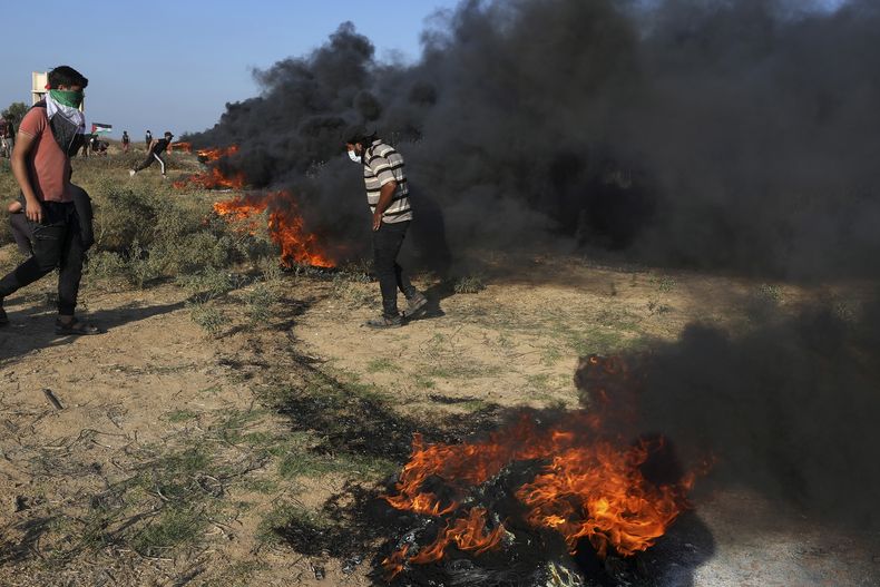 Manifestantes palestinos queman neumáticos durante enfrentamientos con las fuerzas de seguridad israelíes en la frontera con Israel, al este de la ciudad de Gaza, viernes 22 de septiembre de 2023. (AP Foto/Adel Hana)