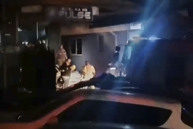Rescatistas se ven ante un club tras un gran incendio la madrugada del domingo en Kocani Macedonia del Norte, el 16 de marzo de 2025. (Kocani TV via AP)