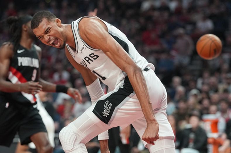 Victor Wembanyama, de los Spurs de San Antonio, reacciona después de encestar durante la primera mitad del cuarto juego de la serie de primera ronda de playoffs del baloncesto de la NBA, el domingo 26 de abril de 2026, en Portland, Oregon. (AP Foto/Jenny Kane)