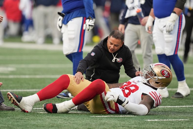 El defensive end de los 49ers de San Francisco Mykel Williams auxiliado por un entrenador tras lesionarse en el cuarto periodo del juego ante los Giants de Nueva York el domingo 2 de noviembre del 2025. (AP Foto/Frank Franklin II)