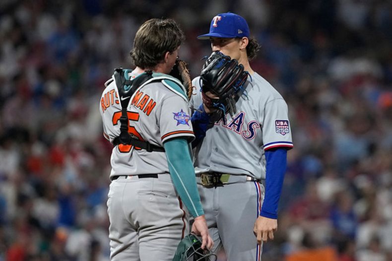 Adley Rutschman, izquierda, de los Orioles de Baltimore, habla con Jacob Latz, de los Rangers de Texas, en la séptima entrada del Juego de Estrellas del béisbol de Grandes Ligas, el martes 14 de julio de 2026, en Filadelfia. (AP Foto/Matt Slocum)
