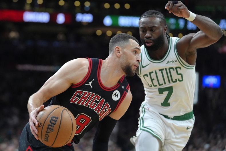 Zach LaVine (8), de los Bulls de Chicago, avanza con el balón ante la presión defensiva de Jaylen Brown (7), de los Celtics de Boston, durante la primera mitad del juego de baloncesto de la NBA, el jueves 19 de diciembre de 2024, en Boston. (AP Foto/Steven Senne)
