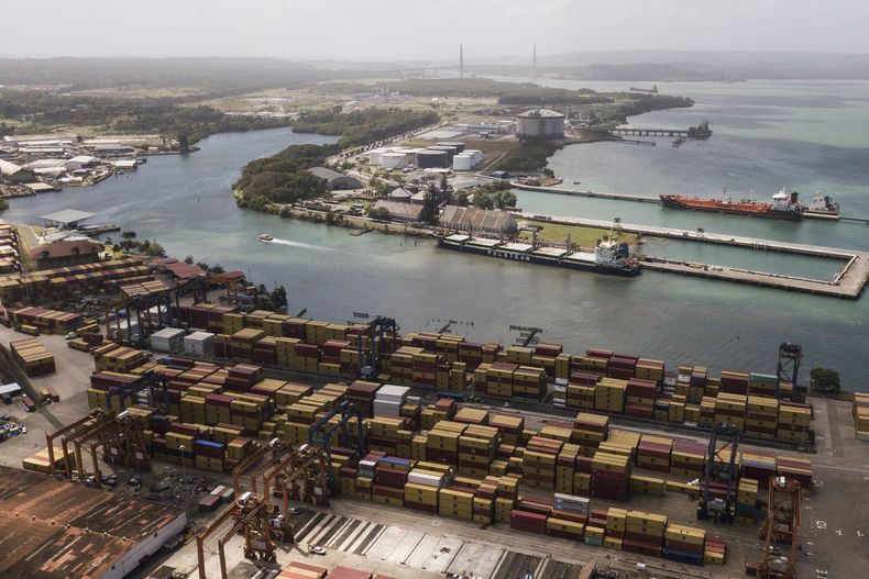 Contenedores de carga, apilados mientras las grúas cargan y descargan buques mercantes en el puerto de Cristóbal, operado por Panama Ports Company, en Colón, el 4 de febrero de 2025. (AP Foto/Matias Delacroix)