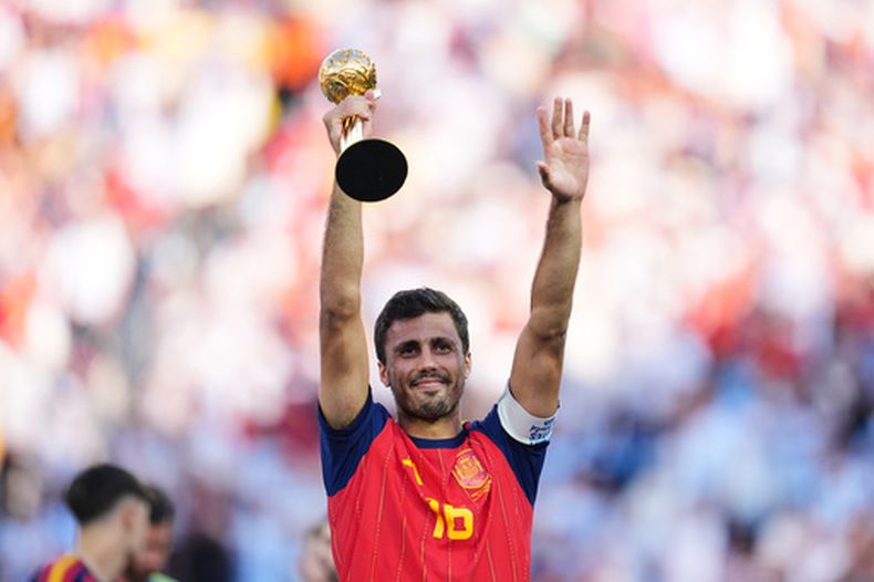 El volante español Rodri Hernández alza el trofeo como mejor jugador del Mundial tras la victoria 1-0 ante Argentina en la final, el domingo 19 de julio de 2026, en East Rutherford, Nueva Jersey. (AP Foto/Abbie Parr)