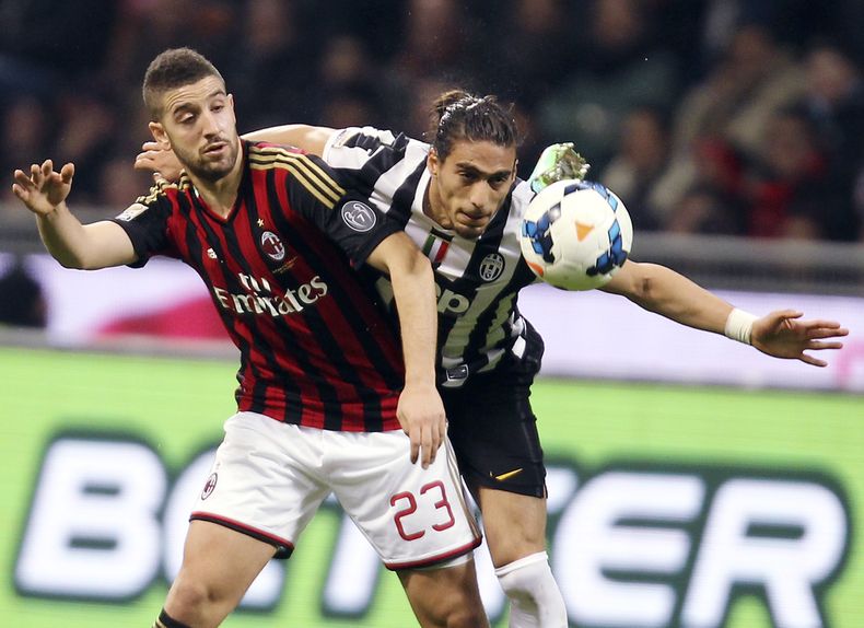Mart&iacute;n C&aacute;ceres (der) pelea un bal&oacute;n con el delantero del Milan Adel Taarabt. El zaguero de Juventus se lastim&oacute; la frente y no podr&aacute; jugar el mi&eacute;rcoles cuando Uruguay enfrente a Austria en un amistoso de fogueo par