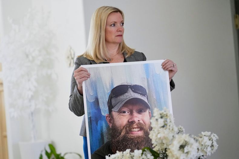 ARCHIVO - Stacey Wales, hermana del fallecido Christopher Pelkey, muestra una foto de su hermano en la casa de su madre, el 7 de mayo de 2025, en Chandler, Arizona. (ap Foto/Matt York/Archivo)