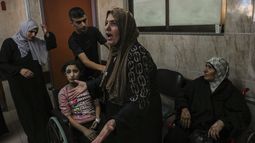Una mujer palestina reacciona junto a varios heridos en el hospital Al-Aqsa de Deir el-Balah, en el centro de la Franja de Gaza, el domingo 15 de octubre de 2023. (AP Foto/Adel Hana)