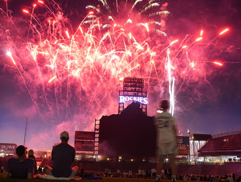 Los espectadores presencian un espectáculo pirotécnico luego que los Rockies de Colorado vencieron a los Reales de Kansas City, el viernes 5 de julio de 2024 (AP Foto/David Zalubowski)