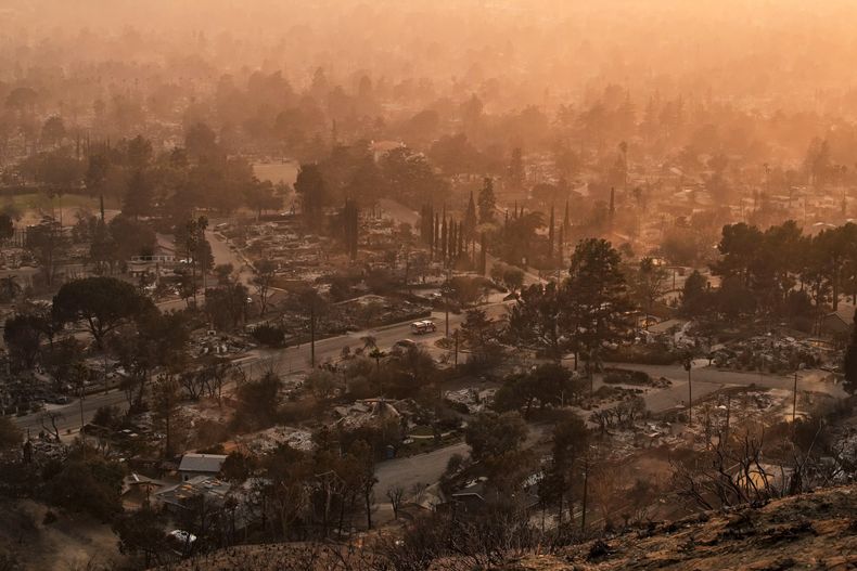 Una nube de humo se alza sobre un vecindario devastado por el incendio Eaton, el jueves 9 de enero de 2025, en Altadena, California. (AP Foto/John Locher)