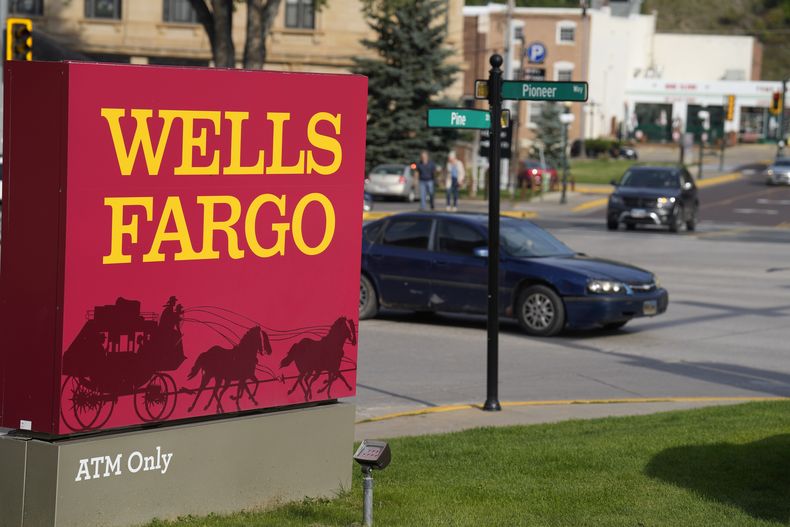 ARCHIVO - Autos pasan frente a un anuncio de una sucursal bancaria de Wells Fargo, el miércoles 20 de septiembre de 2023, en Deadwood, Dakota del Sur. (AP Foto/David Zalubowski, archivo)