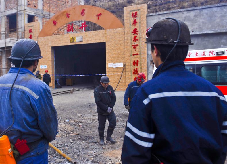 Varios mineros aguardan en la entrada de la mina de carb&oacute;n de Baiyanggou, donde ocurri&oacute; una explosi&oacute;n de gas, en la prefectura de Changji, regi&oacute;n de Xinjiang, en el oeste de China, el viernes 13 de diciembre de 2013. Veinti&uac