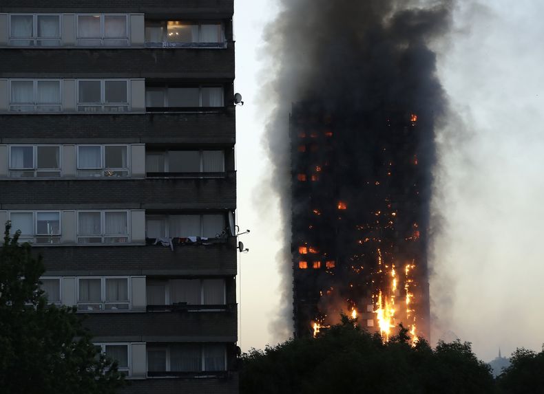 ARCHIVO - En esta foto de archivo del miércoles 14 de junio de 2017, humo y llamas se elevan desde el rascacielos Grenfell Tower, en el oeste de Londres. (AP Foto/Matt Dunham, Archivo)