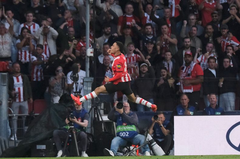 El jugador del PSV Sergiño Dest celebra tras anotar el primer gol de su equipo durante el partido de la fase inicial de la Liga de Campeones de fútbol entre el PSV y el Shakhtar en Eindhoven, Países Bajos, el jueves 10 de septiembre de 2026. (Foto AP/Patrick Post)