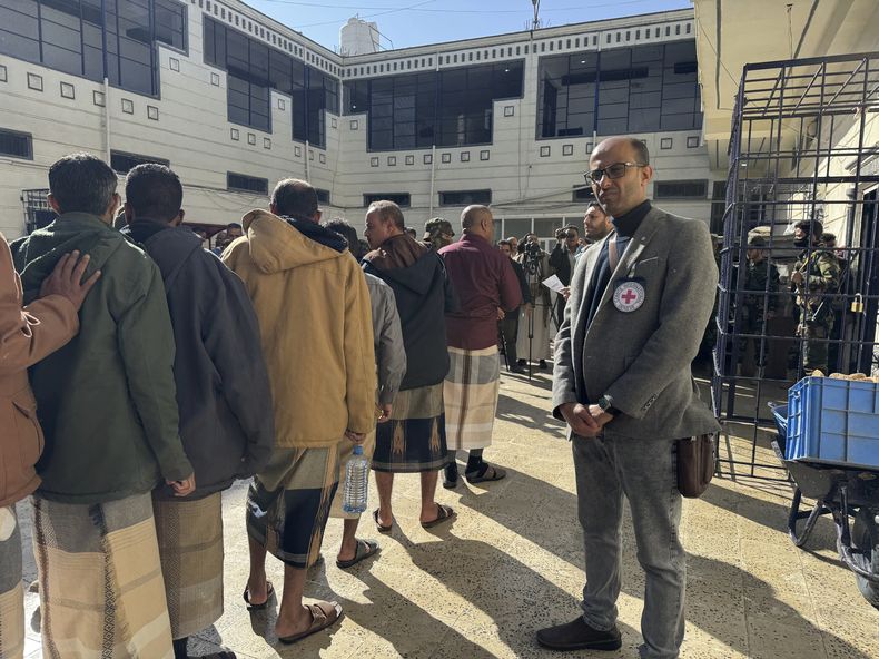 En esta imagen, distribuida por el Comité Internacional de Cruz Roja, personal de la entidad ayuda a prisioneros a prepararse antes de ser liberados por los rebeldes hutíes de Yemen, en la capital del país, Saná, el 25 de enero de 2025. (Comité Internacional de Cruz Roja vía AP)