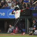 Adolis Garcia (53), de los Rangers de Texas, y el receptor de los Marlins de Miami, Nick Fortes, observan el jonrón solitario de García durante la tercera entrada del juego del béisbol en Arlington, Texas, el viernes 4 de agosto de 2023. (AP Foto/LM Otero)
