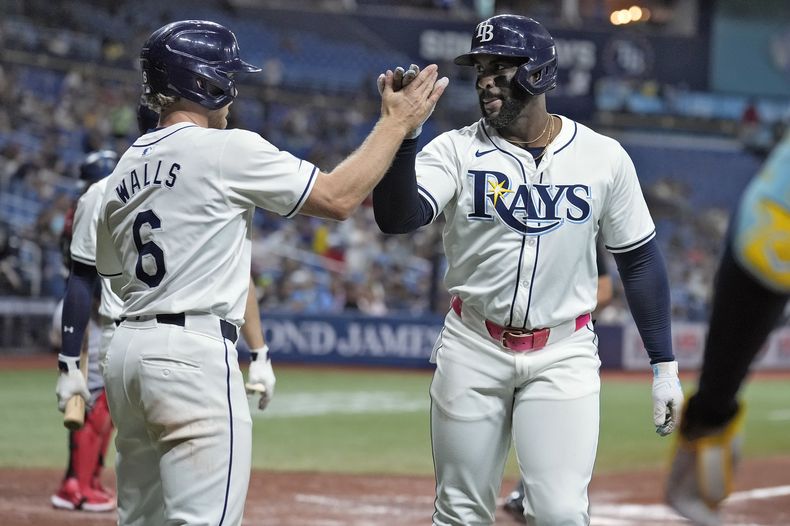 El cubano Yandy Díaz de los Rays de Tampa Bay celebra su jonrón de dos carreras frente al pitcher de los Mellizos de Minnesota Louie Varland con su compañero Taylor Walls el miércoles 4 de septiembre del 2024. (AP Foto/Chris OMeara)