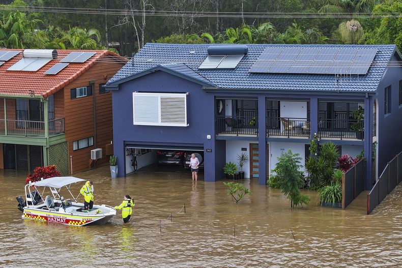 Rescatistas ayudan a una residente que quedó varada en su casa de Port Macquarie, en el norte de Sydney, Australia, a causa de unas inundaciones el jueves 22 de mayo de 2025. (Lindsay Moller/AAP Image via AP)