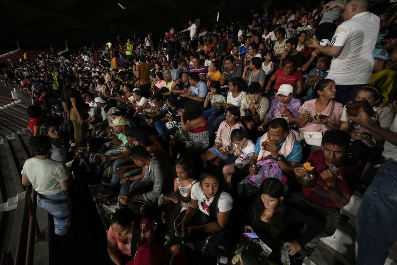 Personas desplazadas por la violencia en localidades de la región del Catatumbo, donde rebeldes del Ejército de Liberación Nacional (ELN) se han enfrentado con exmiembros de las extintas Fuerzas Armadas Revolucionarias de Colombia, se refugian en un estadio de fútbol en Cúcuta, Colombia, el domingo 19 de enero de 2025. (Foto AP/Fernando Vergara)