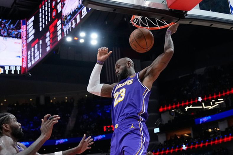El astro de los Lakers de Los Ángeles, LeBron James, realiza una clavada contra los Rockets de Houston durante la segunda mitad de un juego de baloncesto de la NBA, el miércoles 18 de marzo de 2026, en Houston. (Foto AP/David J. Phillip)