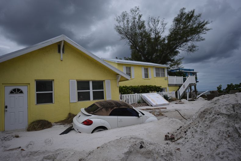 ARCHIVO – Una casa casi enterrada en la arena en Bradenton Beach, Florida, tras el paso del huracán Helene, espera la llegada del huracán Milton, el 8 de octubre de 2024. (AP Foto/Rebecca Blackwell, File)
