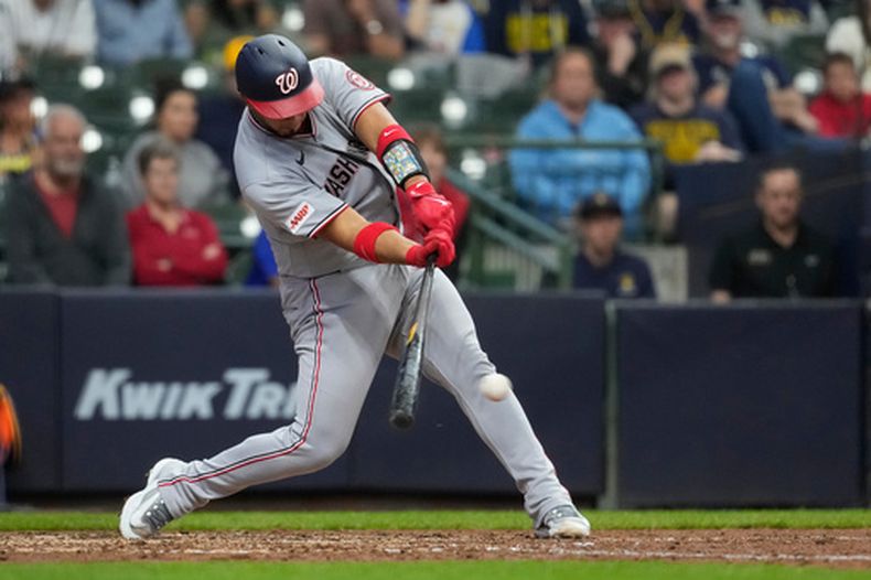 El venezolano de los Nacionales de Washington Keibert Ruiz batea un sencillo de dos carreras en la octava entrada ante los Cerveceros de Milwaukee el domingo 12 de abril del 2026. (AP Foto/Aaron Gash)