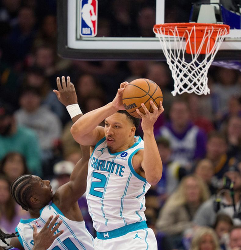Grant Williams, alero de los Hornets de Charlotte, atrapa un rebote frente a su compañero Moussa Diabaté, en el duelo ante el Jazz de Utah, el sábado 10 de enero de 2026 (AP Foto/Bethany Baker)