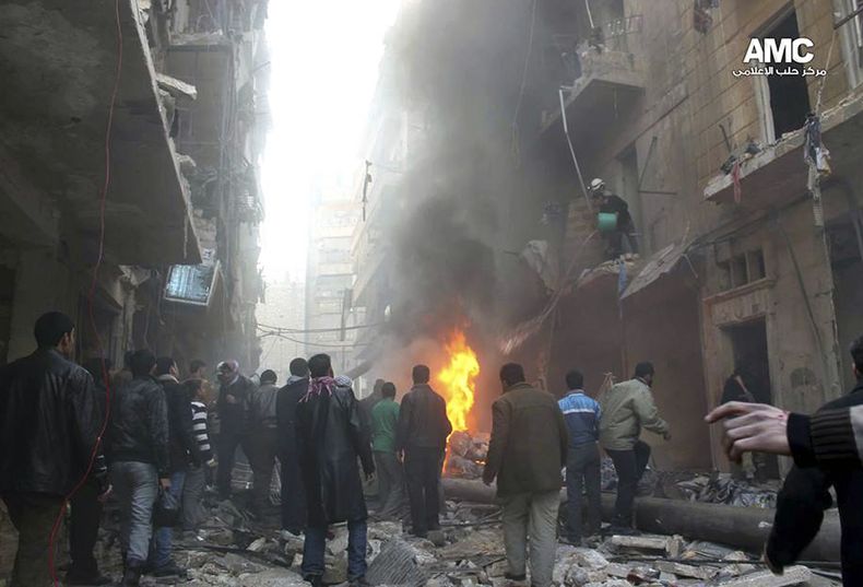 En esta foto del domingo 15 de diciembre del 2013 suministrada por Aleppo Media Center, cuya autenticidad ha sido verificada en base a su contenido y otras labores period&iacute;sticas de la AP, algunos residentes tratan de extinguir las llamas producidas