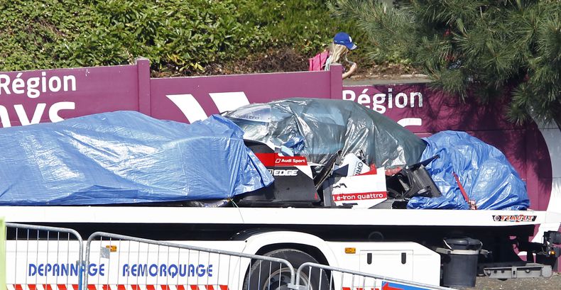 Los restos del Audi de Loic Duval son retirados durante la pr&aacute;ctica para Le Mans el 11 de junio del 2014. Duval, campe&oacute;n vigente, choc&oacute; y fue hospitalizado. (AP Foto/Remy de la Mauviniere)