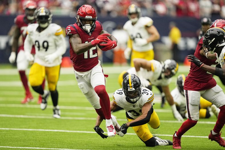 Nico Collins (12), receptor de los Texans de Houston, atrapa un pase y corre con el balón enfrente del safety de los Steelers de Pittsburgh, Minkah Fitzpatrick (39), durante la primera mitad del partido de la NFL, el domingo 1 de octubre de 2023, en Houston. (AP Foto/David J. Phillip)