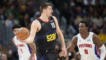 Nikola Jokic (15), pívot de los Nuggets de Denver, busca pasar el balón, ante la presión defensiva de Jalen Duren (0), de los Pistons de Detroit, durante la segunda mitad del juego de baloncesto de la NBA, el domingo 7 de enero de 2024, en Denver. (AP Foto/David Zalubowski)